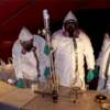 Hazmat-suited enforcement officers dismantle a lab 